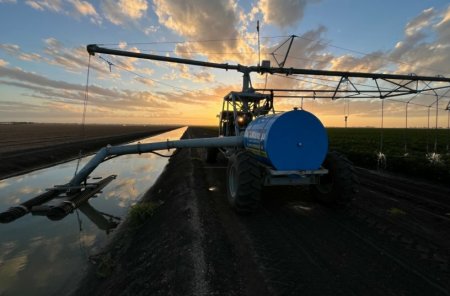 Na fotografii je pivotový závlahový systém odebírající vodu z povrchového zdroje, který zajišťuje závlahu porostu pomocí mobilní čerpací jednotky Warrego Water Services.