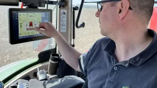 Řidič ovládá dotykový terminál v kabině traktoru