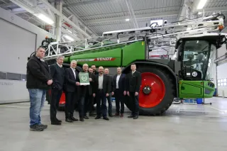 Lidé před zeleným postřikovačem Fendt Rogator ve výrobním závodě