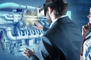 Dva lidé si prohlížejí virtuální model motoru