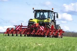 Červený kypřič Lemken za traktorem na poli