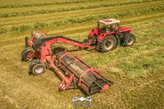 Pásový shrnovač Kuhn Merge Maxx na louce při shrnování píce