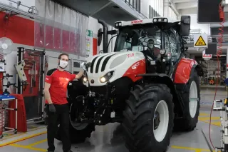 Pracovník u traktoru Steyr ve výrobní hale
