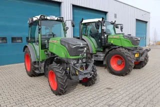 Dva zelené traktory Fendt 200 Vario před budovou