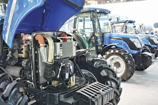 Odkrytý motor modrého traktoru v prodejně náhradních dílů