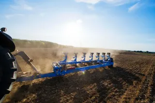 Modrý sedmiradličný pluh Lemken Diamant 16 při orbě na poli.