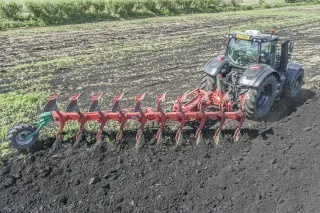 Traktor s podmítacím pluhem Kverneland Ecomat při orbě.