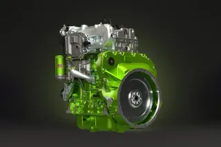 Zelený vodíkový motor JCB na černém pozadí.