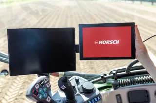 Dva terminály v kabině zemědělského stroje, na jednom je logo Horsch