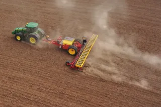 Traktor táhne secí stroj Väderstad Tempo po poli