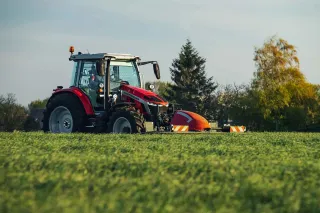 Traktor Massey Ferguson se žacím strojem na louce