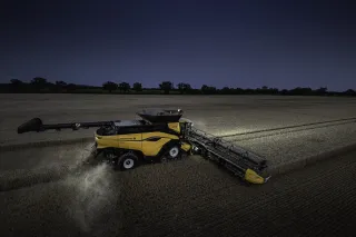 Žlutá sklízecí mlátička New Holland CR11 při sklizni obilí