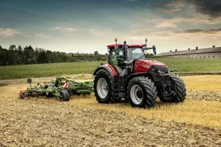 Traktor Case IH Optum s připojeným strojem na louce