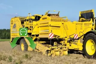 Žlutý sklízeč brambor Ropa Keiler na poli s ukázkou pohonu kol