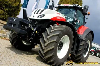 Červeno-bílý traktor Steyr u výstavních vlajek