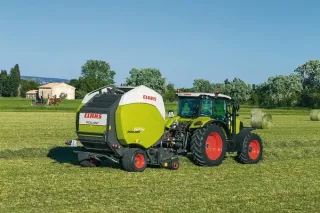 Lis Claas Rollant za zeleným traktorem Claas na louce