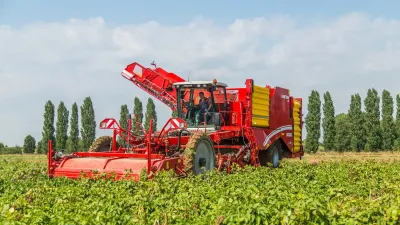 Červený sklízeč brambor Grimme Varitron 470 na poli