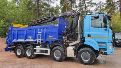 Modrý nákladní vůz Tatra Phoenix s nástavbou ZDT a hydraulickou rukou.