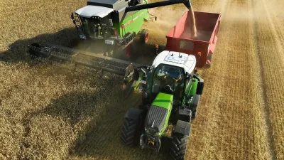 Sklízecí mlátička Fendt sklízí obilí vedle traktoru s přívěsem.