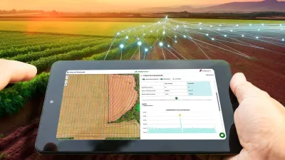 Tablet s mapou pole a grafickým zobrazením digitálního zemědělství