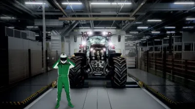 Traktor vystavený v hale za postavou závodníka.
