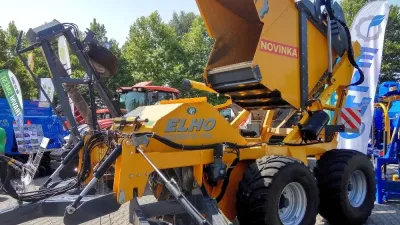 Žlutý stroj Elho na sběr kamenů vystavený na veletrhu