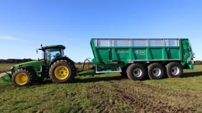 Traktor John Deere táhne rozmetadlo Samson US 340