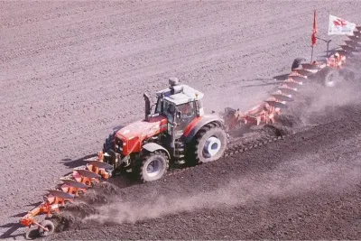 Traktor Massey Ferguson při rekordní orbě s dlouhou soupravou pluhů.
